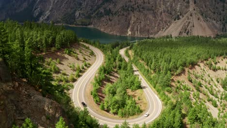 Beautiful-Winding-U-Shaped-Road-Slow---Sunny-Moving-Traffic-Mountain-Forest-View-4K