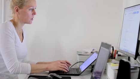 Woman-secretary-in-office-typing-on-her-laptop-stock-footage