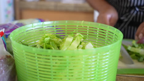 Putting-chopped-romaine-lettuce-in-the-salad-spinner---ANTIPASTO-SALAD-SERIES