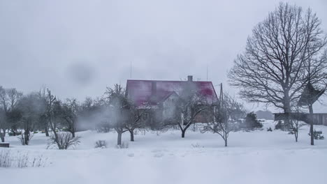 Timelapse-shot-of-cottages-surrounded-by-thick-layer-of-snow-during-winter-season-throughout-a-cloudy-day