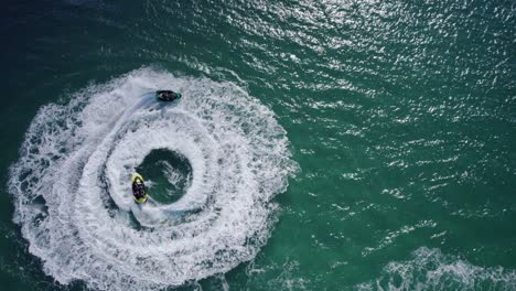 Jetskiing---Jetskiers-Circling-In-The-Water-Leaving-Wake-In-The-Blue-Sea-In-NSW,-Australia