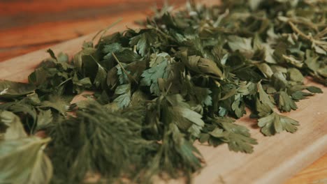 Fresh-coriander-parsley-leaves-stocked-on-cutting-board