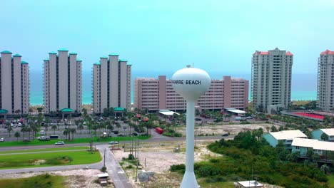 Drone-view-of-the-water-tower-on-Navarre-Beach-FL-circling-clockwise-with-views-of-the-gulf-of-Mexico-and-also-the-bay