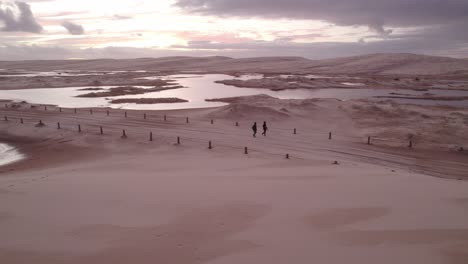People-Walking-In-The-Track-Within-The-Stockton-Sand-Dunes-And-Beach-In-New-South-Wales
