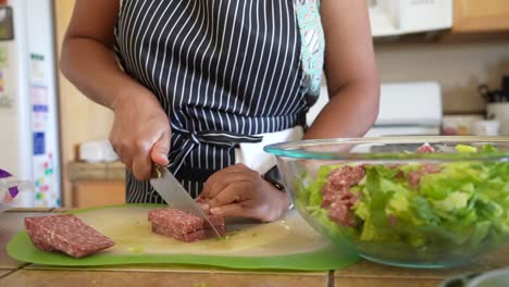 Slicing-salami-to-add-to-a-romaine-lettuce-chopped-salad---ANTIPASTO-SALAD-SERIES