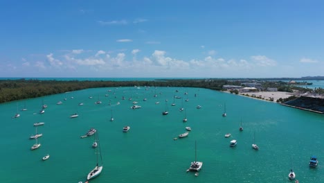 Aerial-view-over-sailboats-moored-at-a-bay-at-sunny-Virginia-Key,-Florida,-USA