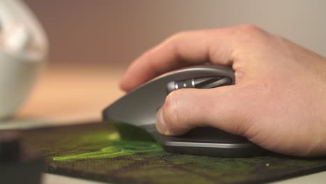 A-close-up-macro-like-view-of-a-hand-furiously-scrolling-on-a-gaming-mouse-wheel-for-a-computer
