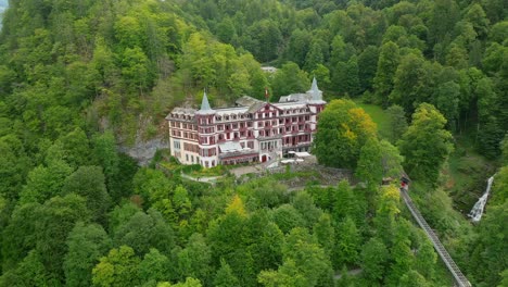 Aerial-rotating-view-of-the-Giessbach-hotel-and-waterfall