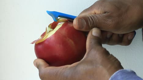 Peeling-an-apple-with-apple-peeler-on-white-background-stock-footage