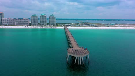 Drone-view-flying-past-and-to-the-right-side-of-the-Navarre-Beach-pier-in-northwest-Florida