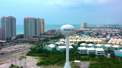 Aerial-drone-view-flying-counter-clockwise-around-the-Navarre-Beach-water-tower-in-northwest-Florida