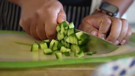 Dicing-cucumbers-on-a-cutting-board-to-add-to-tomato-mixture-for-a-chopped-salad---ANTIPASTO-SALAD-SERIES