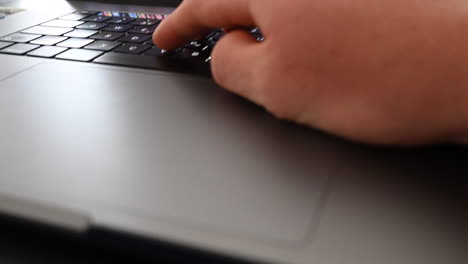 Trackpad-and-keyboards-of-a-laptop,-a-user-is-typing-a-message,-online-communication