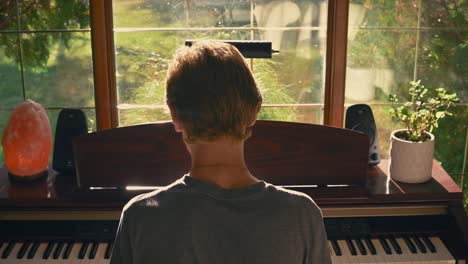 Boy-Playing-Piano-by-a-Window---jib-shot