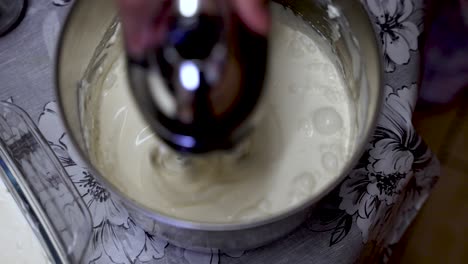 Birds-Eye-View-Of-Cream-Being-Machined-Whisked-In-Metal-Container