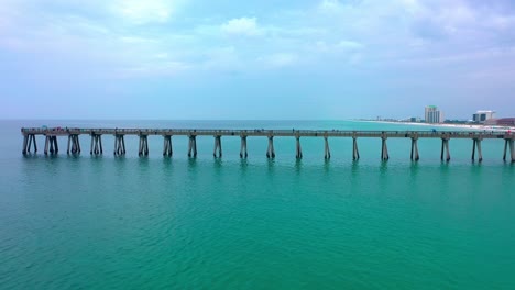 Drone-aerial-shot-flying-down-the-side-of-the-Navarre-Beach-FL-pier
