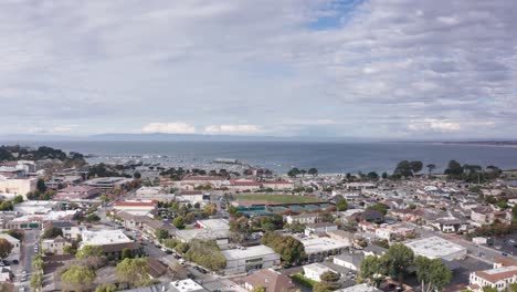 Aerial-wide-panning-shot-of-Monterey-Bay-from-downtown-Monterey,-California