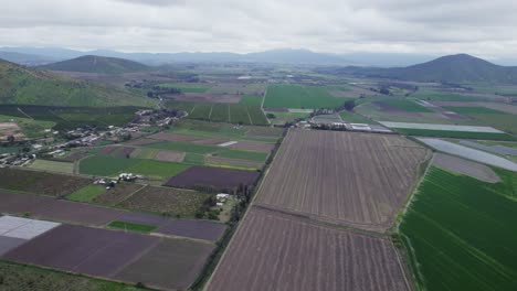 Panoramic-View-Of-Agricultural-Land-With-Fields-And-Mountains-In-Pomaire-Near-Santiago-de-Chile