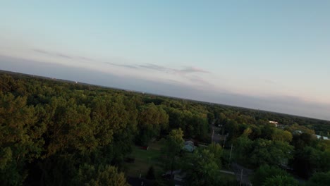Drone-speedily-turn-backward-and-capture-the-entire-forested-area-at-twilight