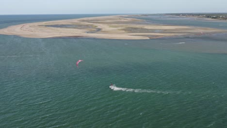 Drone-following-a-kitesurfer-on-Ilha-do-Guajiru,-Brazil