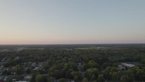 Drone-hovering-at-a-great-height-and-capturing-the-whole-area-which-include-small-town-surrounded-by-tree