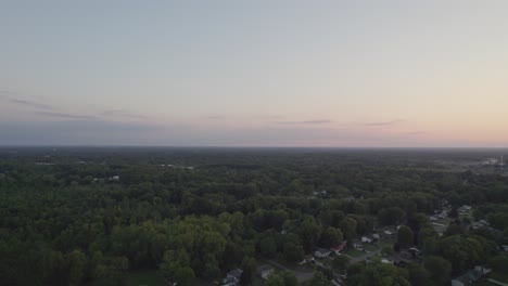Ohio's-small-town-with-trees-surrounding-it-is-captured-by-a-drone-in-the-evening-from-a-very-high-altitude