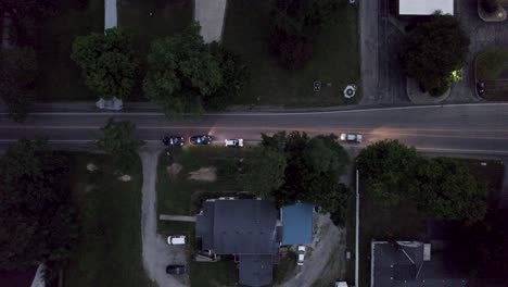 An-aerial-shot-of-a-cop-car-pulls-over-a-speeding-driver-on-the-main-road-in-the-evening-time