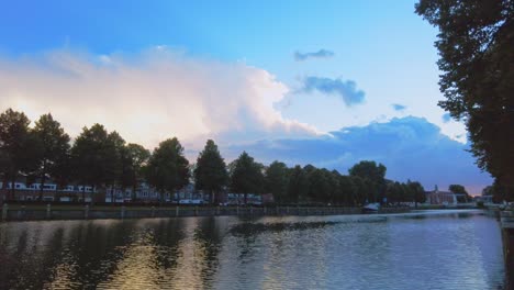 Sunset-left-to-right-timelapse-at-canal-quay-dutch-delta-river-the-maas-den-bosch