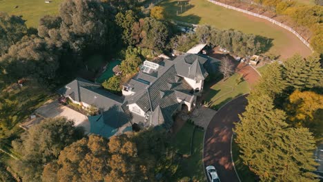 Drone-footage-of-an-estate-house-during-sunset-4K-25FPS