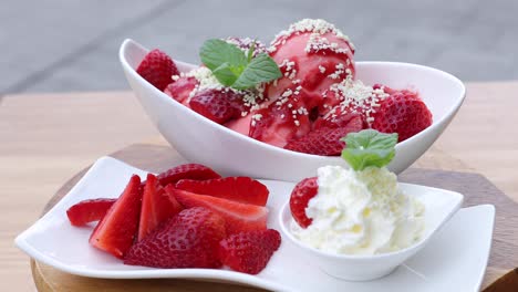 Strawberry-ice-cream-with-a-small-portion-of-whipped-cream-and-decorated-with-mint