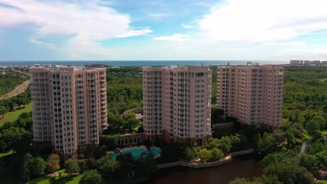 Drone-aerial-view-of-One-Water-Place-Condominium-in-Destin-Florida-next-to-the-mid-bay-bridge
