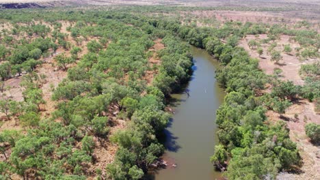 Low-and-rising-aerial-footage-over-the-Victoria-River-at-Kalkaringi,-Northern-Territory,-Australia