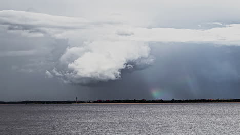 Time-lapse-footage-of-dense-clouds-over-Seanad-rainbow-in-background