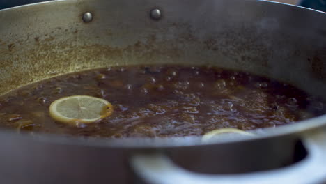 Fresh-Yellow-Sliced-Lemon-Being-Placed-In-Simmering-Curry-Sauce-And-Being-Stirred-1