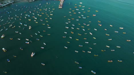 Aerial-orbit-of-several-yellow-boats-in-Tongoy-cove,-northern-Chile