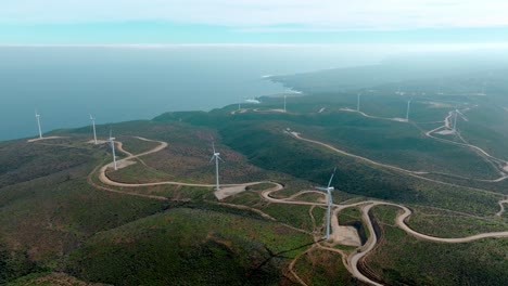 Aerial-orbit-of-a-line-of-wind-turbines-on-a-sunny-day-at-the-sea-shore