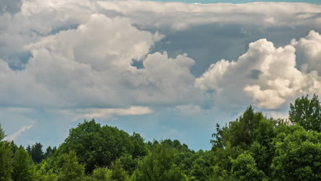 Shot-of-white-fluffy-clouds-slowly-float-through-the-blue-daytime-sky-in-timelapse