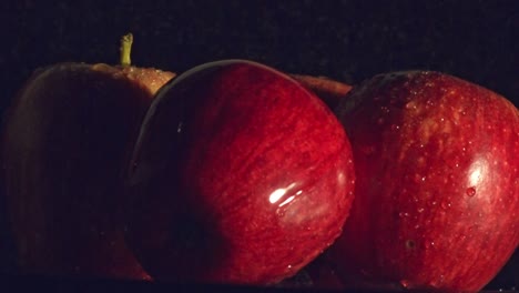 Water-droplets-falling-onto-red-apple-1