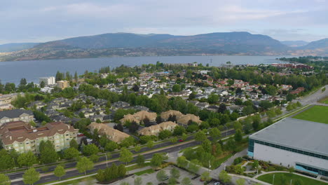 Fly-over-aerial-view-of-a-parking-lot-and-suburban-sprawl-in-Kelowna-near-the-Okanagan-Lake-on-a-beautiful,-sunny-summer-day