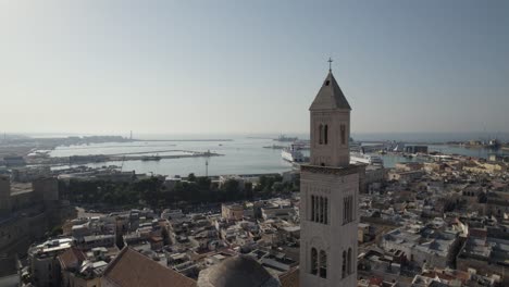 Aerial-Dolly-Past-Bari-Cathedral-Tower-Out-Towards-Port-Of-Bari-In-Southeastern-Italy
