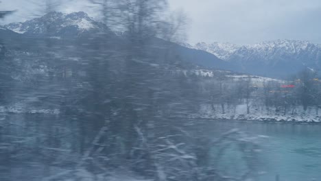 Window-shot-of-landscape-train-during-severe-winter