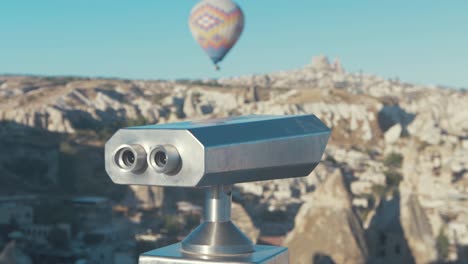 Binoculars-at-Aşıklar-Tepesi-overlooking-hot-air-balloon-at-Cappadocia