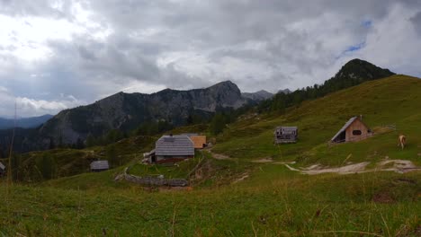 Timelapse-filmed-on-top-of-a-mountain-called-Krstenica-in-the-Slovenian-mountains-in-the-alps-with-surrounding-houses,-mountains,-and-animals