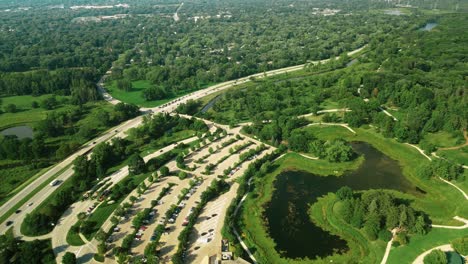 An-aerial-shot-of-a-clean-walking-area-along-with-the-green-trees-and-beautiful-flowers-in-the-Arboretum-Park