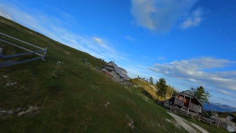 Fpv-footage-was-filmed-in-the-Slovenian-mountain-village-in-the-alps-with-a-drone-flying-fast-over-mountains-filmed-with-a-GoPro-with-surrounding-landscapes-flying-between-and-over-small-wooden-cabins