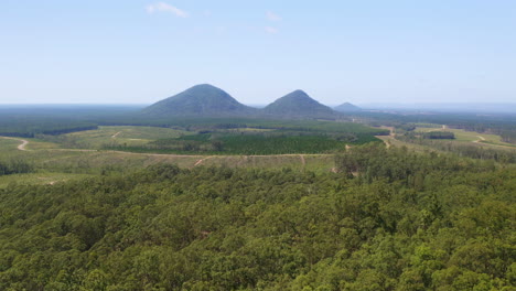 Aerial-Drone-View-Over-Green-Glasshouse-Mountain-Rural-Countryside-And-Trees,-4K