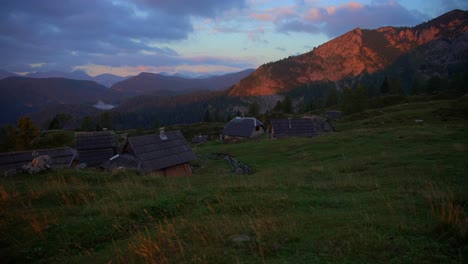 Movement-with-a-gimbal-of-footage-in-the-Slovenian-mountains-up-in-the-alps-at-an-incredible-sunrise-in-beautiful-colors-with-a-camera-going-slowly-forward-in-a-small-mountain-wooden-village