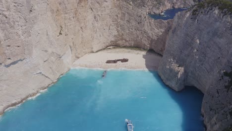 Aerial---Shipwreck-general-shot-in-Zakynthos,-Greece---Flying-backwards-and-high