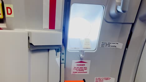 Zoom-in-on-Airbus-airplane-galley-window-with-door-closed-and-armed-during-flight