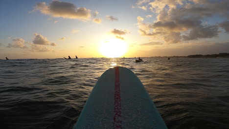 Majestic-sunset-view-from-longboard-on-calm-ocean-surface,-POV